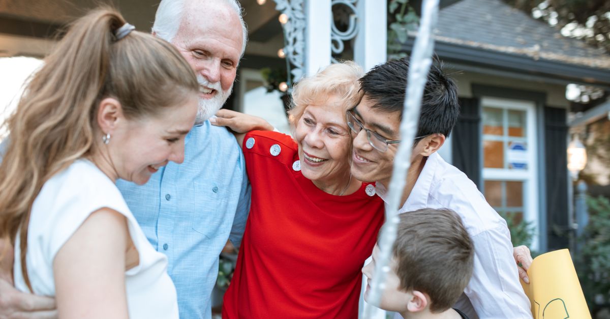 Family visiting and supporting an elderly relative at the residential home